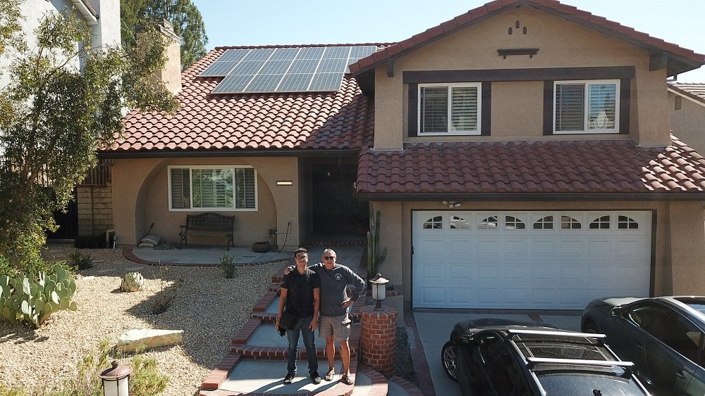 A picture in front of a home with solar and our customer